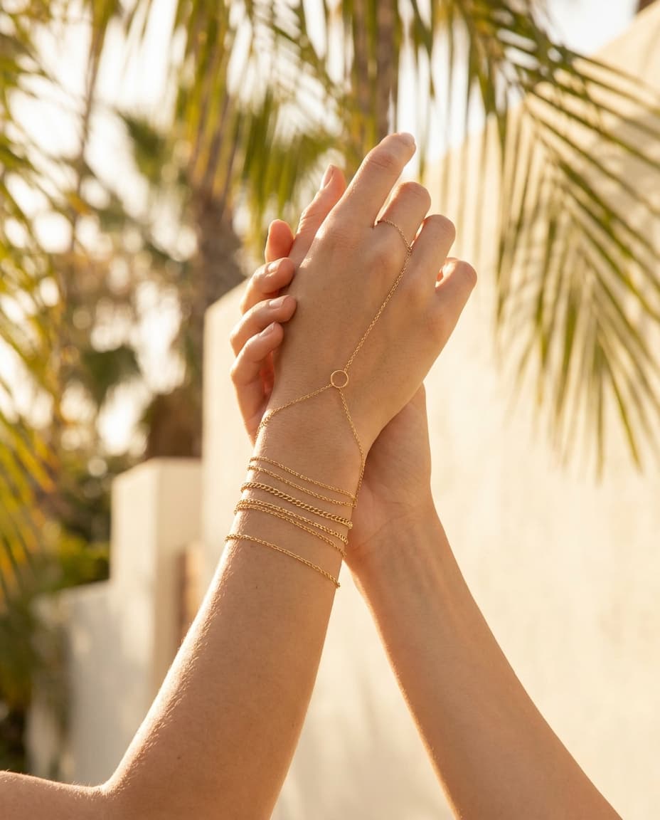 Stacked gold permanent jewelry by Bond & Fifth